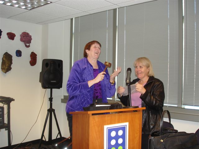 GCB Board Meeting-Former President Marsha Farrow presenting Current President Alice Richhard with a gaval symbolizing passing on the presidency.