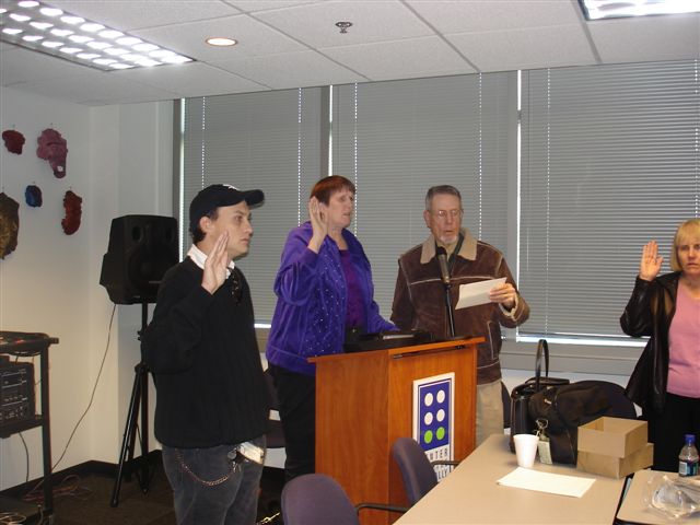 GCB Board Meeting-Left to right-Brian Lieghton 2nd V.P., Alice Ritchhart President, and John M Sims reading the oath.